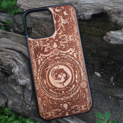 Intricately designed wood phone case featuring a yin-yang koi fish motif surrounded by detailed ornamental patterns and symbolic script. Laser-engraved for precision and durability, this case is compatible with iPhone , 15, 14, 13, 12, 11, Pro Max, Mini, and Samsung Galaxy S, S24, S23, S22, S21, S20 Ultra, Plus, Note 20. A unique and artistic accessory for those seeking elegance and protection.