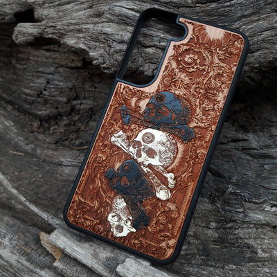 Laser-engraved skull design on a wooden phone case