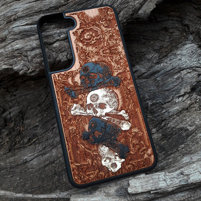 Laser-engraved skull design on a wooden phone case