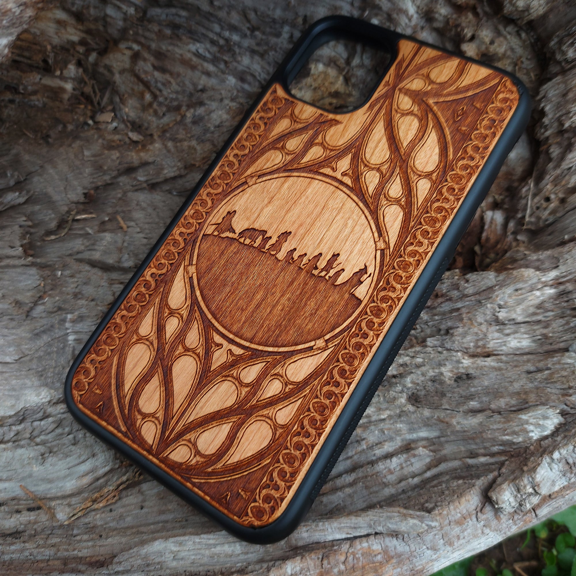 Lord of the Rings wood phone case featuring the Fellowship of the Ring silhouette and intricate Elvish-inspired patterns. Laser-engraved for detailed artistry and durability, this case is compatible with iPhone 16, 15, 14, 13, 12, 11, Pro Max, Mini, and Samsung Galaxy S25, S24, S23, S22, S21, S20 Ultra, Plus, Note 20. A stylish and protective accessory for Tolkien fans.