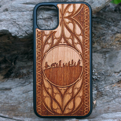 Lord of the Rings wood phone case featuring the Fellowship of the Ring silhouette and intricate Elvish-inspired patterns. Laser-engraved for detailed artistry and durability, this case is compatible with iPhone , 15, 14, 13, 12, 11, Pro Max, Mini, and Samsung Galaxy S, S24, S23, S22, S21, S20 Ultra, Plus, Note 20. A stylish and protective accessory for Tolkien fans.