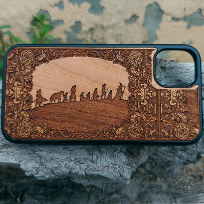Lord of the Rings wood phone case featuring the Fellowship of the Ring silhouette and ornate border design. Laser-engraved for intricate detailing, this case combines durability with artistry. Compatible with iPhone , 15, 14, 13, 12, 11, Pro Max, Mini, and Samsung Galaxy S, S24, S23, S22, S21, S20 Ultra, Plus, Note 20. Perfect for Tolkien fans seeking a unique and protective accessory.