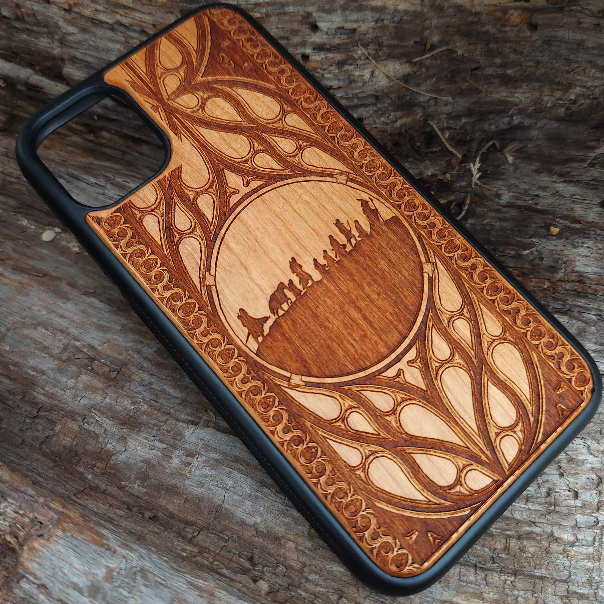 Lord of the Rings wood phone case featuring the Fellowship of the Ring silhouette and intricate Elvish-inspired patterns. Laser-engraved for detailed artistry and durability, this case is compatible with iPhone 16, 15, 14, 13, 12, 11, Pro Max, Mini, and Samsung Galaxy S25, S24, S23, S22, S21, S20 Ultra, Plus, Note 20. A stylish and protective accessory for Tolkien fans.