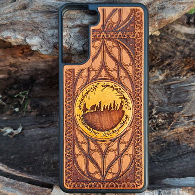 Hand-painted Lord of the Rings wood phone case featuring the Fellowship of the Ring silhouette surrounded by Elvish script and intricate patterns. The golden accent highlights the design, making it a unique and artistic piece. Laser-engraved for durability, this case is compatible with iPhone , 15, 14, 13, 12, 11, Pro Max, Mini, and Samsung Galaxy S, S24, S23, S22, S21, S20 Ultra, Plus, Note 20. A perfect accessory for Tolkien fans seeking style and protection.