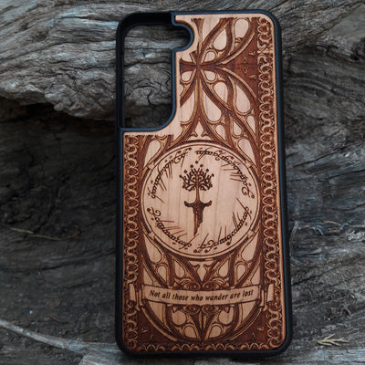 Lord of the Rings wood phone case featuring the White Tree of Gondor, Elvish script, and the iconic quote 'Not all those who wander are lost.' Laser-engraved for intricate detailing and crafted for durability, this case is compatible with iPhone , 15, 14, 13, 12, 11, Pro Max, Mini, and Samsung Galaxy S, S24, S23, S22, S21, S20 Ultra, Plus, Note 20. A perfect protective accessory for Tolkien fans.