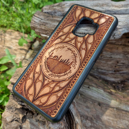 Lord of the Rings wood phone case featuring the Fellowship of the Ring silhouette surrounded by Elvish script and intricate, elegant patterns. Laser-engraved for precision and durability, this case is compatible with iPhone 16, 15, 14, 13, 12, 11, Pro Max, Mini, and Samsung Galaxy S25, S24, S23, S22, S21, S20 Ultra, Plus, Note 20. A unique and protective accessory for Tolkien fans.