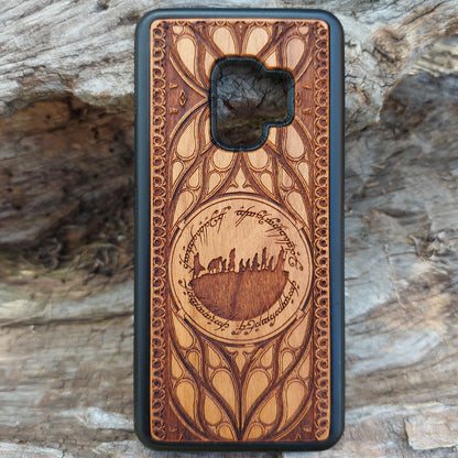 Lord of the Rings wood phone case featuring the Fellowship of the Ring silhouette surrounded by Elvish script and intricate, elegant patterns. Laser-engraved for precision and durability, this case is compatible with iPhone 16, 15, 14, 13, 12, 11, Pro Max, Mini, and Samsung Galaxy S25, S24, S23, S22, S21, S20 Ultra, Plus, Note 20. A unique and protective accessory for Tolkien fans.