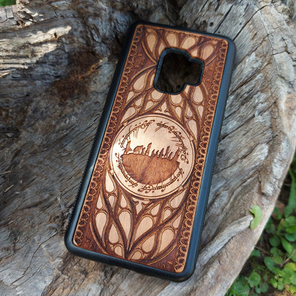 Lord of the Rings wood phone case featuring the Fellowship of the Ring silhouette surrounded by Elvish script and intricate, elegant patterns. Laser-engraved for precision and durability, this case is compatible with iPhone 16, 15, 14, 13, 12, 11, Pro Max, Mini, and Samsung Galaxy S25, S24, S23, S22, S21, S20 Ultra, Plus, Note 20. A unique and protective accessory for Tolkien fans.