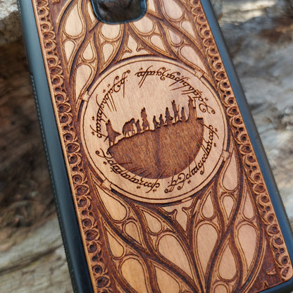Lord of the Rings wood phone case featuring the Fellowship of the Ring silhouette surrounded by Elvish script and intricate, elegant patterns. Laser-engraved for precision and durability, this case is compatible with iPhone 16, 15, 14, 13, 12, 11, Pro Max, Mini, and Samsung Galaxy S25, S24, S23, S22, S21, S20 Ultra, Plus, Note 20. A unique and protective accessory for Tolkien fans.