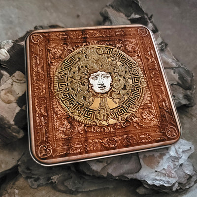 Close-up of Medusa's face engraved on dark wood wireless charger.