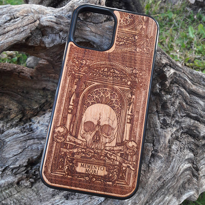 Laser-engraved Memento Mori wood phone case featuring a skull, crossbones, and intricate Gothic patterns with "Memento Mori" text for iPhone  and Samsung Galaxy S. Perfect for Gothic and philosophical design lovers.