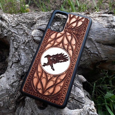 Handcrafted wood phone case with intricate raven design. Compatible with iPhone 15, 14, 13, 12, 11 Pro Max Mini and Samsung Galaxy S24, S23, S22, S21, S20 Ultra Plus Note. Durable, slim, and unique—order now!