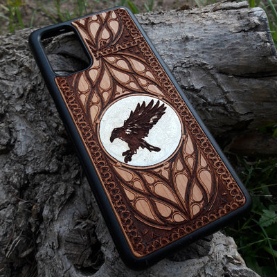 Handcrafted wood phone case with intricate raven design. Compatible with iPhone 15, 14, 13, 12, 11 Pro Max Mini and Samsung Galaxy S24, S23, S22, S21, S20 Ultra Plus Note. Durable, slim, and unique—order now!