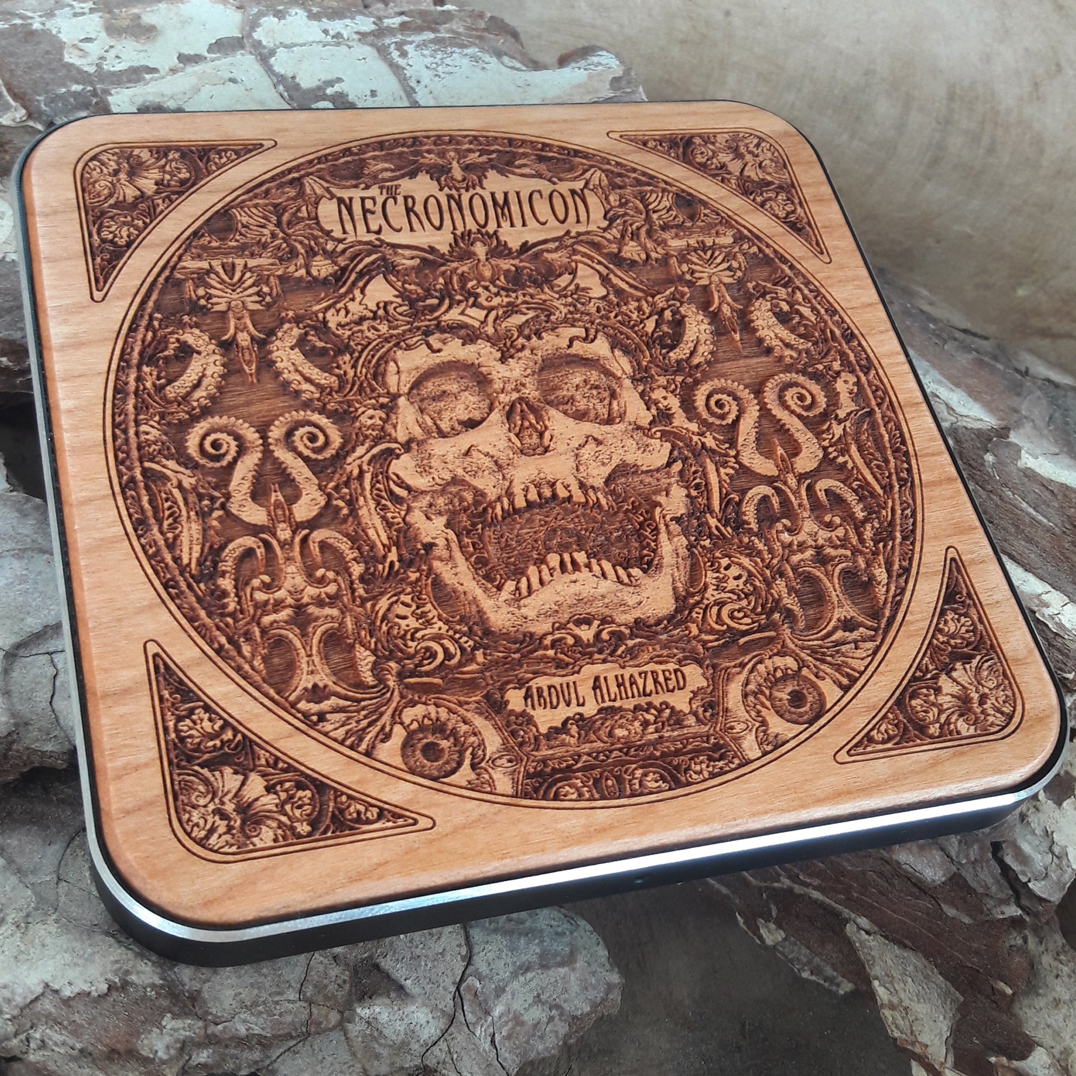 Overhead view of occult designs on Necronomicon wireless charger.