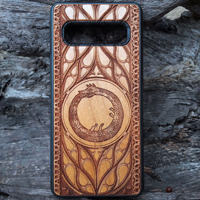 Eco friendly wood phone case carved with a beautiful Ouroboros design. Celtic Triskelion Spiral wood phone case with laser-engraved design for iPhone & Samsung Galaxy. Compatible with iPhone , 15, 14, 13, 12, 11 Pro Max Mini & Samsung Galaxy S, S24, S23, S22, S21, S20 Ultra Plus Note 20. Unique and durable.