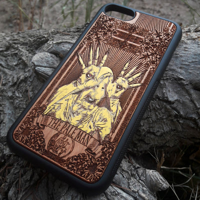 Laser-engraved Pale Man design from Pan's Labyrinth on a wooden phone case, compatible with iPhone 16, Galaxy S25, and more.