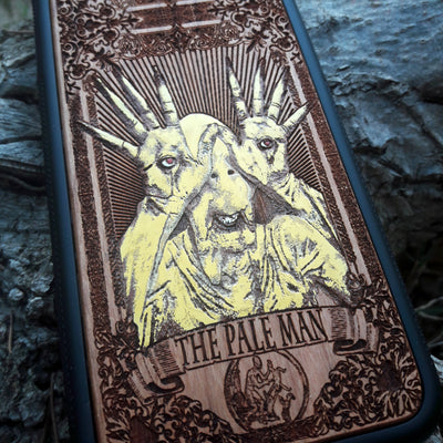 Laser-engraved Pale Man design from Pan's Labyrinth on a wooden phone case, compatible with iPhone 16, Galaxy S25, and more.