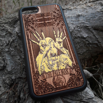 Laser-engraved Pale Man design from Pan's Labyrinth on a wooden phone case, compatible with iPhone 16, Galaxy S25, and more.