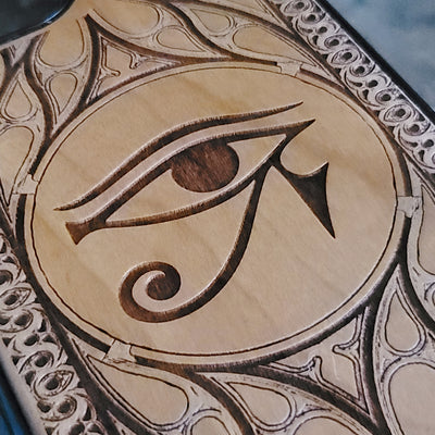 Wooden phone case featuring the Eye of Ra design, laser-engraved for iPhone & Samsung Galaxy. Compatible with iPhone 15, 14, 13, 12, 11 Pro Max Mini, Samsung Galaxy S24, S23, S22, S21, S20 Ultra Plus, and Note 20. Unique, durable, and slim.
