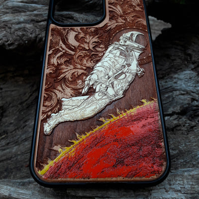 Hand-painted astronaut wooden phone case featuring a laser-engraved cosmic design on cherrywood. Compatible with iPhone -11 Pro Max, Galaxy S-S20. Sci-fi and space-themed phone case.