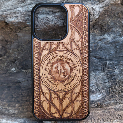 Lord of the Rings wood phone case featuring the Eye of Sauron surrounded by Elvish script and intricate, elegant patterns. Laser-engraved for durability and unique artistry, this case is compatible with iPhone 16, 15, 14, 13, 12, 11, Pro Max, Mini, and Samsung Galaxy S25, S24, S23, S22, S21, S20 Ultra, Plus, Note 20. A stunning and protective accessory for Tolkien fans.