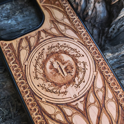 Lord of the Rings wood phone case featuring the Eye of Sauron surrounded by Elvish script and intricate, elegant patterns. Laser-engraved for durability and unique artistry, this case is compatible with iPhone 16, 15, 14, 13, 12, 11, Pro Max, Mini, and Samsung Galaxy S25, S24, S23, S22, S21, S20 Ultra, Plus, Note 20. A stunning and protective accessory for Tolkien fans.