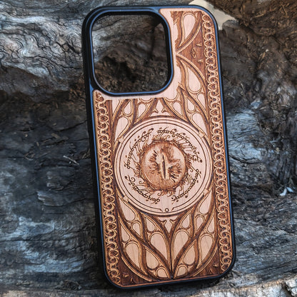 Lord of the Rings wood phone case featuring the Eye of Sauron surrounded by Elvish script and intricate, elegant patterns. Laser-engraved for durability and unique artistry, this case is compatible with iPhone 16, 15, 14, 13, 12, 11, Pro Max, Mini, and Samsung Galaxy S25, S24, S23, S22, S21, S20 Ultra, Plus, Note 20. A stunning and protective accessory for Tolkien fans.