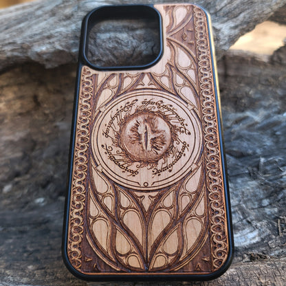 Lord of the Rings wood phone case featuring the Eye of Sauron surrounded by Elvish script and intricate, elegant patterns. Laser-engraved for durability and unique artistry, this case is compatible with iPhone 16, 15, 14, 13, 12, 11, Pro Max, Mini, and Samsung Galaxy S25, S24, S23, S22, S21, S20 Ultra, Plus, Note 20. A stunning and protective accessory for Tolkien fans.