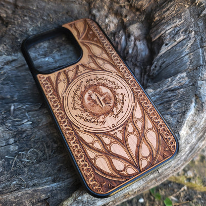 Lord of the Rings wood phone case featuring the Eye of Sauron surrounded by Elvish script and intricate, elegant patterns. Laser-engraved for durability and unique artistry, this case is compatible with iPhone 16, 15, 14, 13, 12, 11, Pro Max, Mini, and Samsung Galaxy S25, S24, S23, S22, S21, S20 Ultra, Plus, Note 20. A stunning and protective accessory for Tolkien fans.