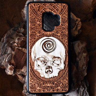 Laser-engraved skull art on a wooden phone case, compatible with iPhone 16, iPhone 15, Galaxy S25, and more.