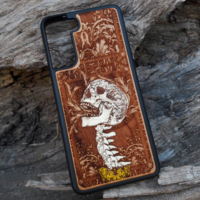 Gothic skull artwork engraved on a wooden phone case, compatible with iPhone and Samsung Galaxy