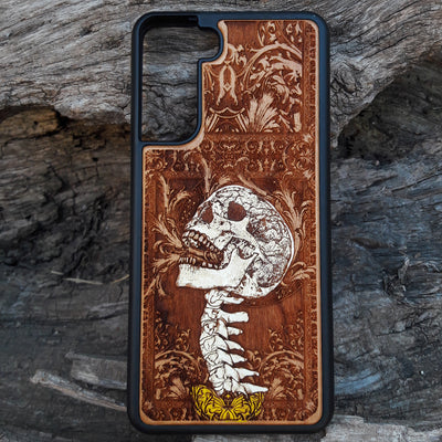 Gothic skull artwork engraved on a wooden phone case, compatible with iPhone and Samsung Galaxy