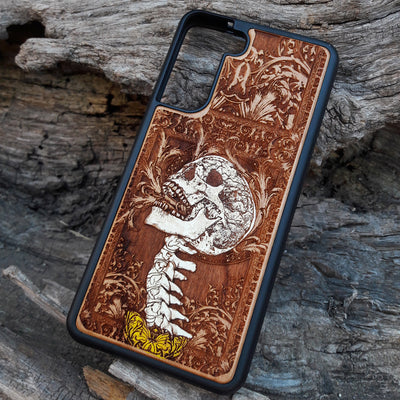 Gothic skull artwork engraved on a wooden phone case, compatible with iPhone and Samsung Galaxy