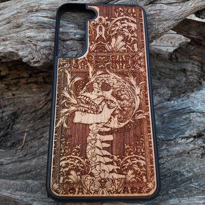Wooden phone case with a detailed carved skull design from Scream, available for iPhone , iPhone 15, Galaxy S, Galaxy S24, and more. Perfect for fans of horror and gothic art, offering durability and unique style.