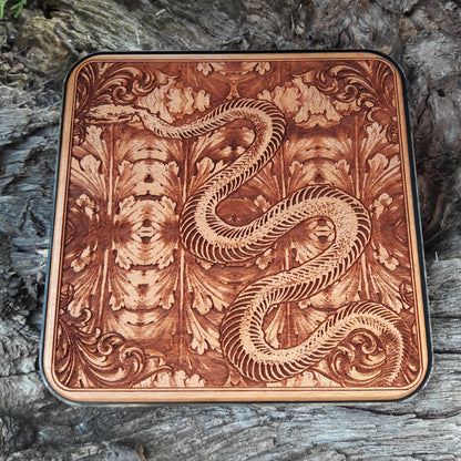Minimalist desk featuring skeleton snake wood charging pad.
