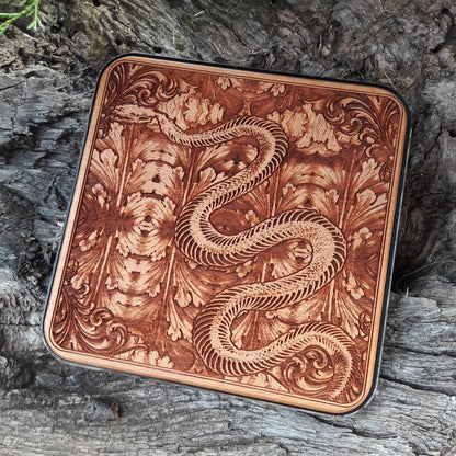 Side view of slim wood charger featuring gothic skeleton snake art.