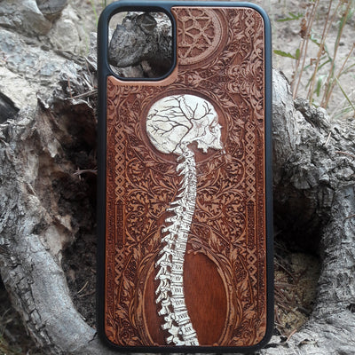 Laser-engraved skeleton spine design on a wooden phone case, compatible with iPhone and samsung galaxy