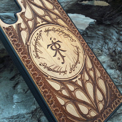 Tolkien-inspired wood phone case featuring the J.R.R. Tolkien monogram, Elvish script, and intricate designs. Laser-engraved for a unique and detailed look, this durable case is compatible with iPhone , 15, 14, 13, 12, 11, Pro Max, Mini, and Samsung Galaxy S, S24, S23, S22, S21, S20 Ultra, Plus, Note 20. A perfect protective accessory for Lord of the Rings fans.