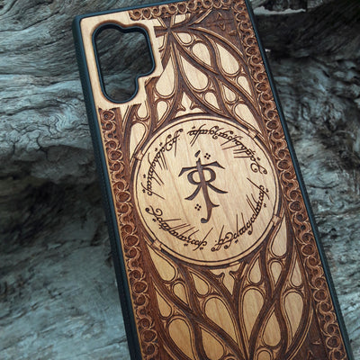 Tolkien-inspired wood phone case featuring the J.R.R. Tolkien monogram, Elvish script, and intricate designs. Laser-engraved for a unique and detailed look, this durable case is compatible with iPhone , 15, 14, 13, 12, 11, Pro Max, Mini, and Samsung Galaxy S, S24, S23, S22, S21, S20 Ultra, Plus, Note 20. A perfect protective accessory for Lord of the Rings fans.
