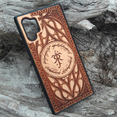 Tolkien-inspired wood phone case featuring the J.R.R. Tolkien monogram, Elvish script, and intricate designs. Laser-engraved for a unique and detailed look, this durable case is compatible with iPhone , 15, 14, 13, 12, 11, Pro Max, Mini, and Samsung Galaxy S, S24, S23, S22, S21, S20 Ultra, Plus, Note 20. A perfect protective accessory for Lord of the Rings fans.