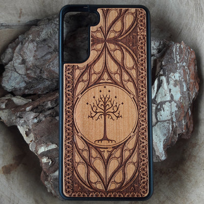 Lord of the Rings wood phone case featuring the White Tree of Gondor with intricate Elvish-inspired patterns. Laser-engraved for elegance and durability, this case is compatible with iPhone , 15, 14, 13, 12, 11, Pro Max, Mini, and Samsung Galaxy S, S24, S23, S22, S21, S20 Ultra, Plus, Note 20. A stylish and protective accessory for Tolkien fans.