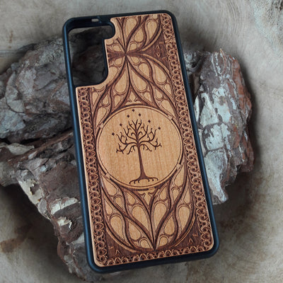Lord of the Rings wood phone case featuring the White Tree of Gondor with intricate Elvish-inspired patterns. Laser-engraved for elegance and durability, this case is compatible with iPhone , 15, 14, 13, 12, 11, Pro Max, Mini, and Samsung Galaxy S, S24, S23, S22, S21, S20 Ultra, Plus, Note 20. A stylish and protective accessory for Tolkien fans.