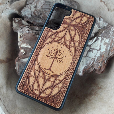 Lord of the Rings wood phone case featuring the White Tree of Gondor with intricate Elvish-inspired patterns. Laser-engraved for elegance and durability, this case is compatible with iPhone , 15, 14, 13, 12, 11, Pro Max, Mini, and Samsung Galaxy S, S24, S23, S22, S21, S20 Ultra, Plus, Note 20. A stylish and protective accessory for Tolkien fans.