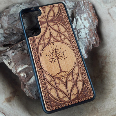 Lord of the Rings wood phone case featuring the White Tree of Gondor with intricate Elvish-inspired patterns. Laser-engraved for elegance and durability, this case is compatible with iPhone , 15, 14, 13, 12, 11, Pro Max, Mini, and Samsung Galaxy S, S24, S23, S22, S21, S20 Ultra, Plus, Note 20. A stylish and protective accessory for Tolkien fans.