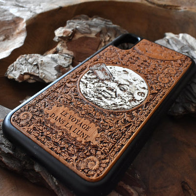 Laser-engraved "A Trip to the Moon" design on a wooden phone case, compatible with iPhone 16, iPhone 15, Galaxy S25, Note 20, and more.