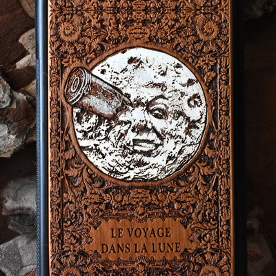 Laser-engraved "A Trip to the Moon" design on a wooden phone case, compatible with iPhone 16, iPhone 15, Galaxy S25, Note 20, and more.