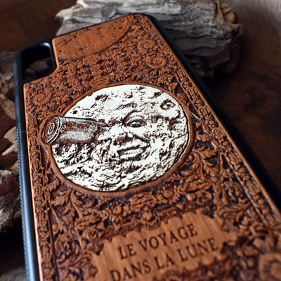 Laser-engraved "A Trip to the Moon" design on a wooden phone case, compatible with iPhone 16, iPhone 15, Galaxy S25, Note 20, and more.