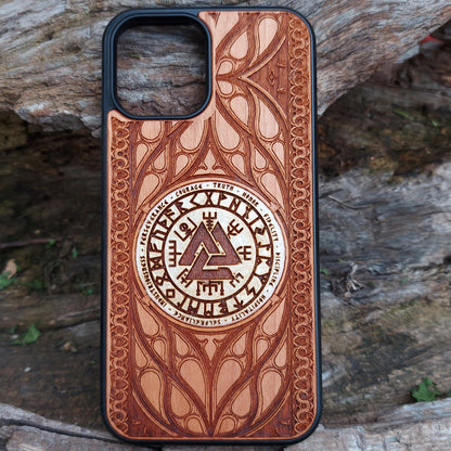 Nordic-inspired wooden phone case featuring a Valknut symbol surrounded by runic designs, precision-engraved for a bold and meaningful statement. This protective case is a perfect fit for iPhone 16, 15, 14, 13, 12, 11, Pro Max, Mini, and Samsung Galaxy S25, S24, S23, S22, S21, S20 Ultra, Plus, Note 20. Ideal for those who admire Norse mythology and elegant craftsmanship.