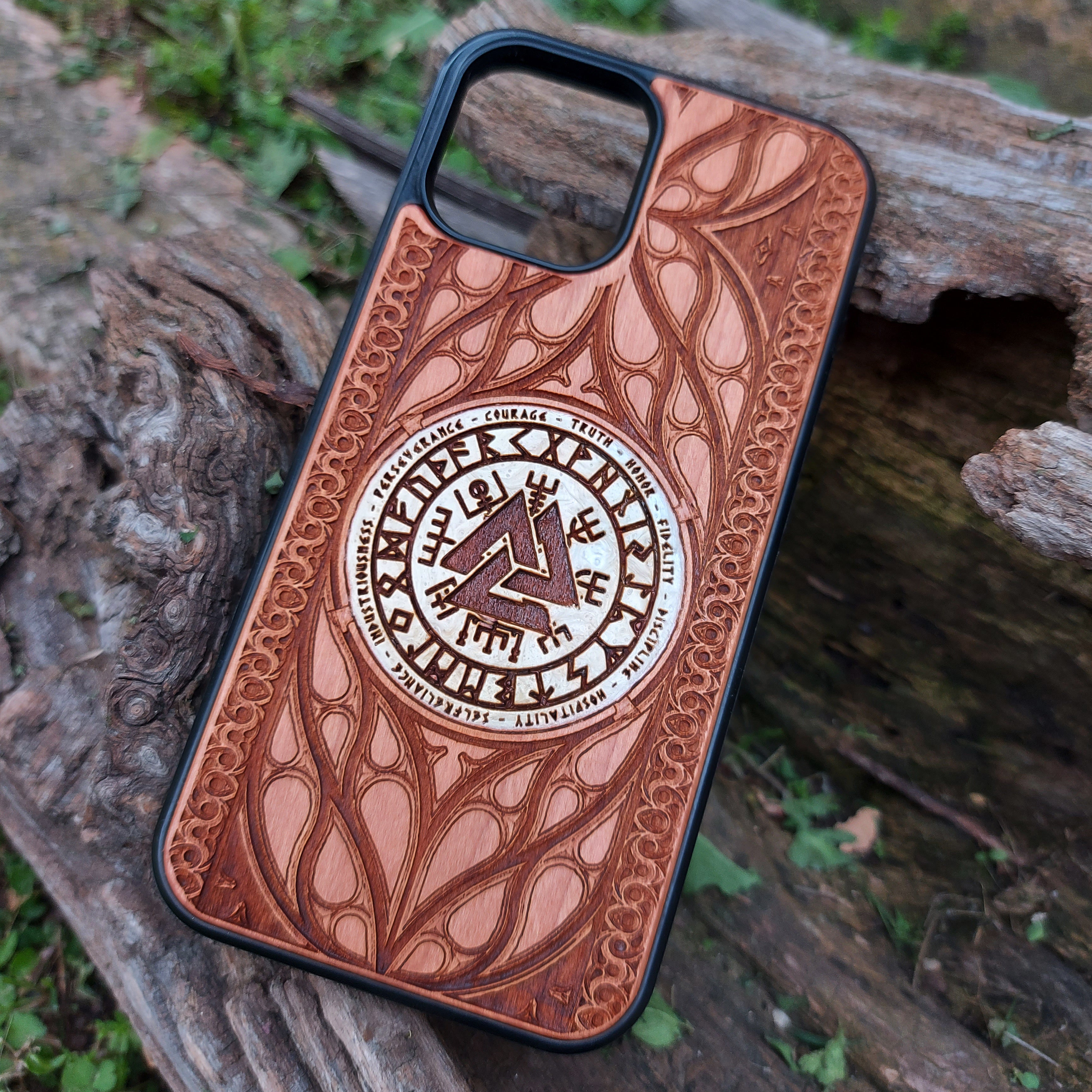 Nordic-inspired wooden phone case featuring a Valknut symbol surrounded by runic designs, precision-engraved for a bold and meaningful statement. This protective case is a perfect fit for iPhone 16, 15, 14, 13, 12, 11, Pro Max, Mini, and Samsung Galaxy S25, S24, S23, S22, S21, S20 Ultra, Plus, Note 20. Ideal for those who admire Norse mythology and elegant craftsmanship.