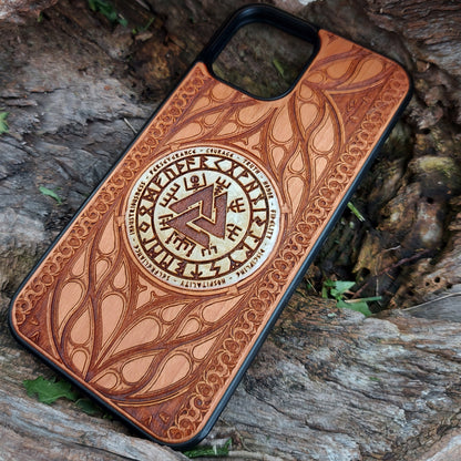 Nordic-inspired wooden phone case featuring a Valknut symbol surrounded by runic designs, precision-engraved for a bold and meaningful statement. This protective case is a perfect fit for iPhone 16, 15, 14, 13, 12, 11, Pro Max, Mini, and Samsung Galaxy S25, S24, S23, S22, S21, S20 Ultra, Plus, Note 20. Ideal for those who admire Norse mythology and elegant craftsmanship.